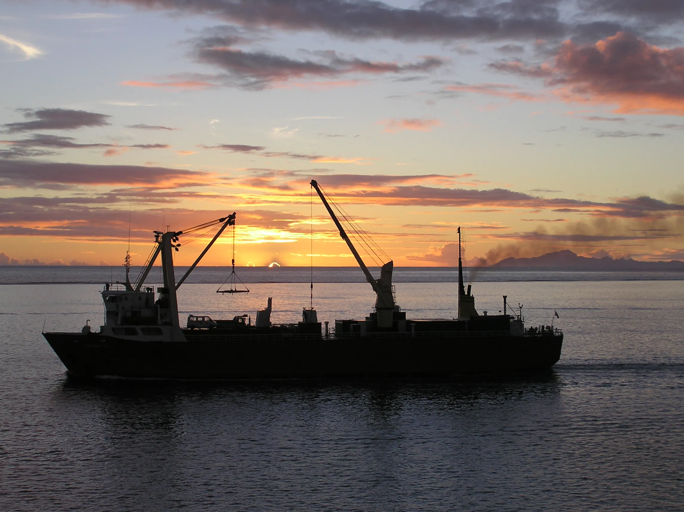 Sun setting over ship in Tahiti